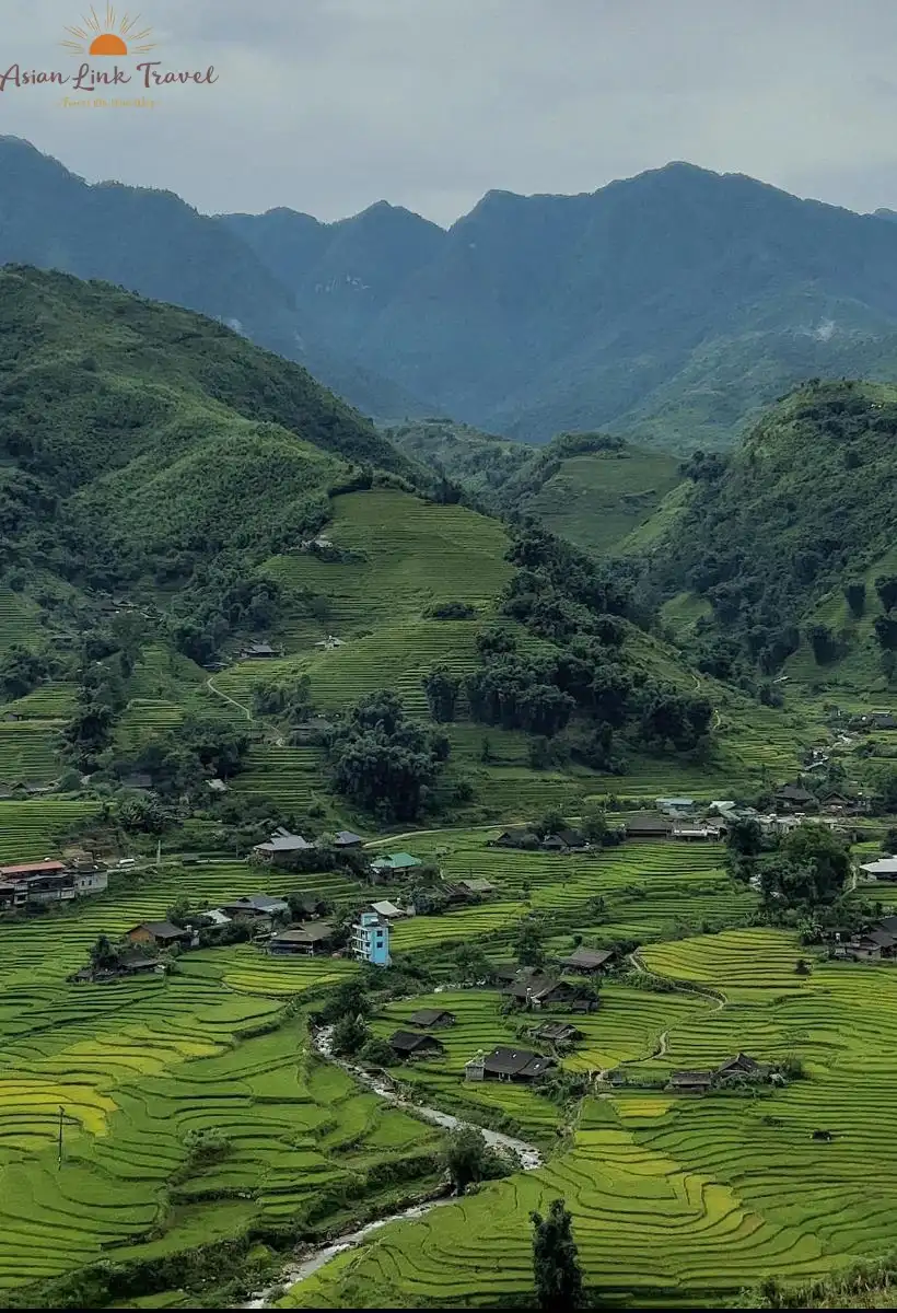 A tranquil village nestled among lush green rice terraces in Northern Vietnam.